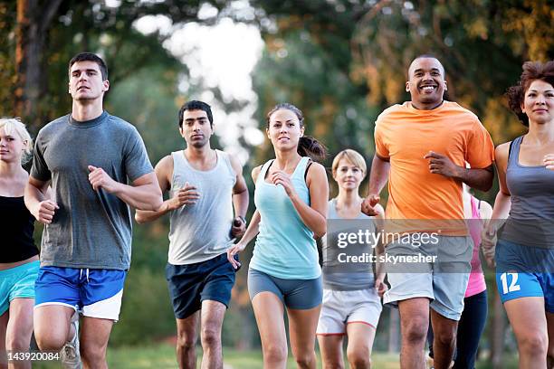 group of runners in a cross country race. - 10000 meter stock pictures, royalty-free photos & images