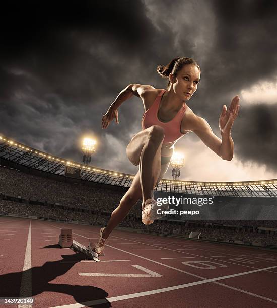 athlete bursts out of starting blocks - woman starting line stock pictures, royalty-free photos & images