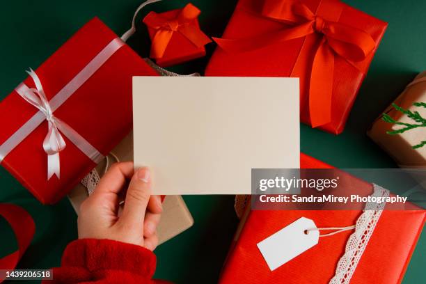 directly above woman's hand holding mockup postcard with presents - card mock up stockfoto's en -beelden