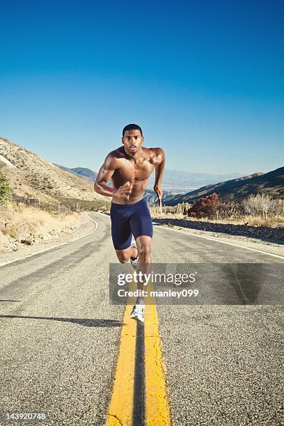 black male athlete running on desert road - black male bodybuilders 個照片及圖片檔