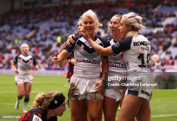 Tara-Jane Stanley of England celebrates their hat trick try and their sides tenth try with team mates during the Women's Rugby League World Cup Group...