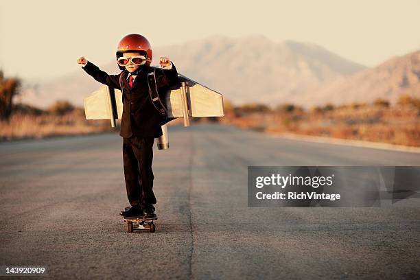 young boy wearing business suit and jet pack - jet pack stock pictures, royalty-free photos & images