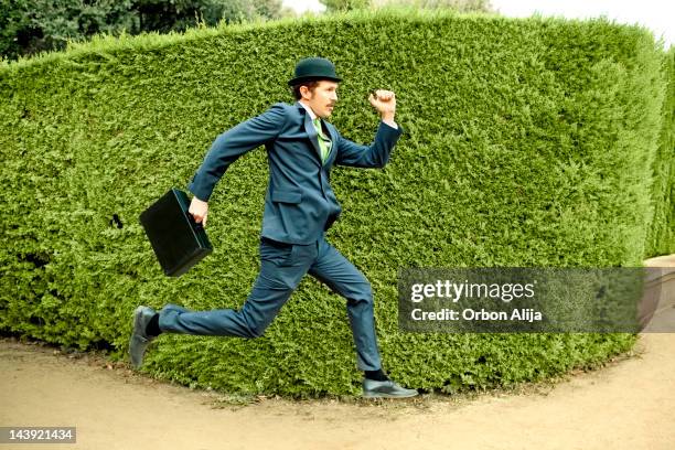 classic businessman running - hat and suit stock pictures, royalty-free photos & images