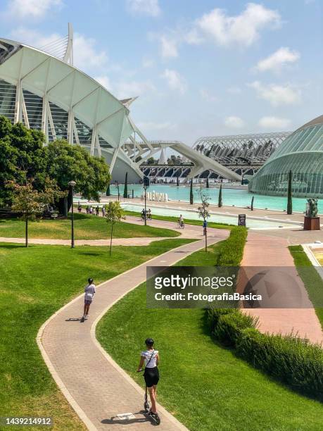 using push scooters and bikes in the city of the arts and sciences in valencia, spain - images royalty free stock pictures, royalty-free photos & images