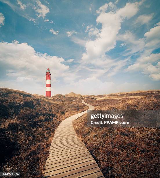 lighthouse in the dunes - wattenmeer national park stock pictures, royalty-free photos & images