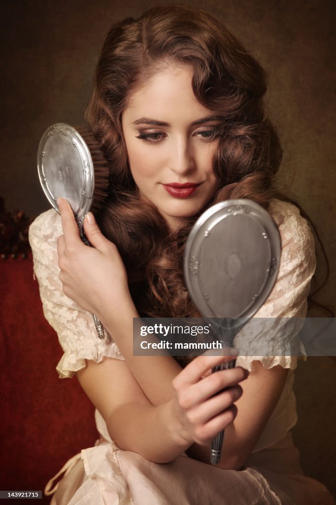 Romantic girl combing her hair