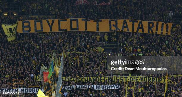Fans of Dortmund hold banners in protest to the upcoming FIFA World Cup in Qatar prior to the Bundesliga match between Borussia Dortmund and VfL...