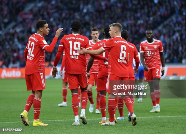 Jamal Musiala of Bayern Munich celebrates with teammates after scoring their team's first goal during the Bundesliga match between Hertha BSC and FC...