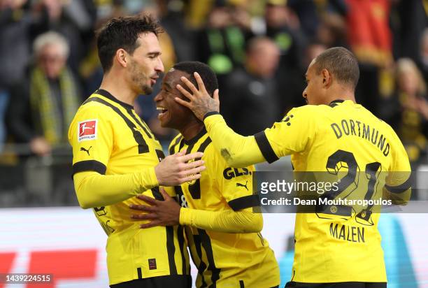 Youssoufa Moukoko of Dortmund celebrates scoring his team's first goal with Mats Hummels and Donyell Malen during the Bundesliga match between...