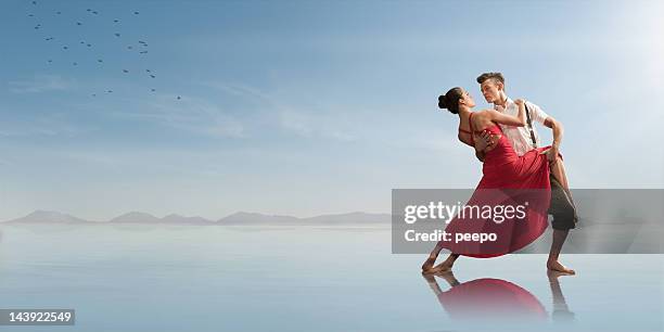 romantic couple dancing on the beach - couple red dress stock pictures, royalty-free photos & images
