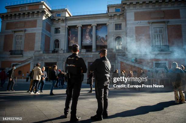 Two policemen at the gates of the Prado Museum on November 5 in Madrid, Spain. Two activists of Futuro Vegetal have glued themselves to the frames of...