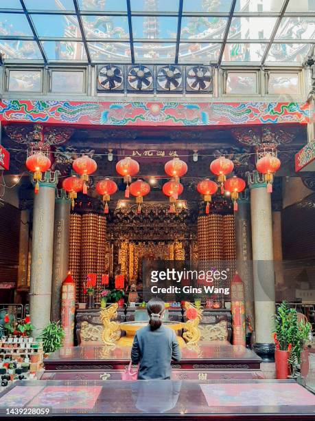 a woman is praying in a old temple. - lunar new year bildbanksfoton och bilder
