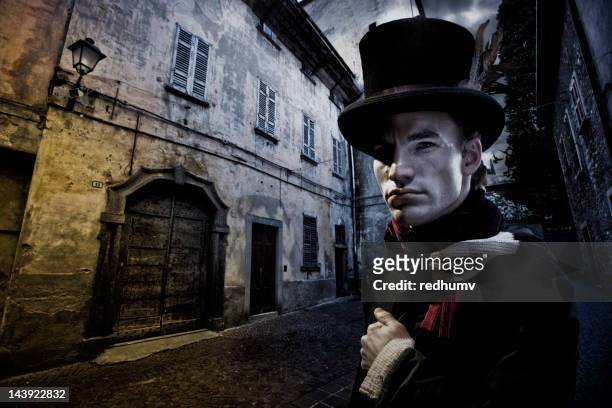 vintage man in tophat and cobblestone street - top hat stock pictures, royalty-free photos & images