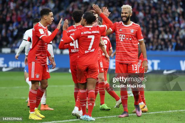 Eric Maxim Choupo-Moting of Bayern Munich celebrates with teammates after scoring their team's third goal during the Bundesliga match between Hertha...