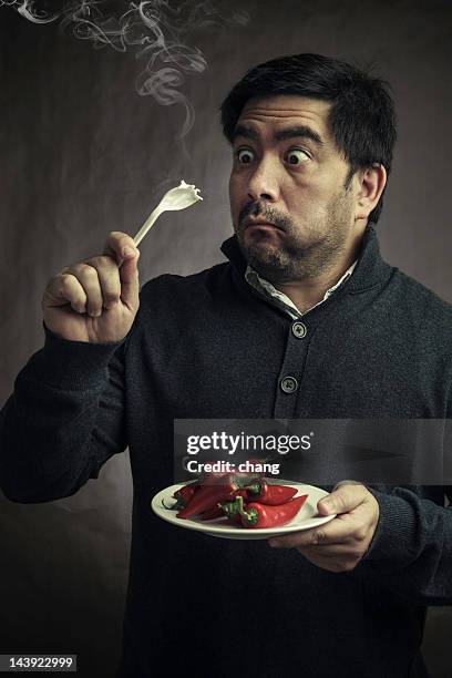 hot pepper - eating spicy food stock pictures, royalty-free photos & images