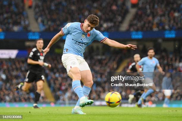 Julian Alvarez of Manchester City scores their team's first goal during the Premier League match between Manchester City and Fulham FC at Etihad...