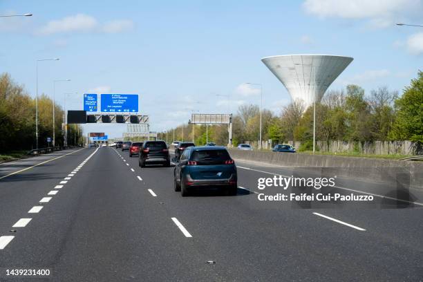 traffic on highwang and water tower at roadside near wexford - traffic stock pictures, royalty-free photos & images