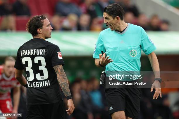 Referee Deniz Aytekin makes a point to Luca Pellegrini of Frankfurt during the Bundesliga match between FC Augsburg and Eintracht Frankfurt at...