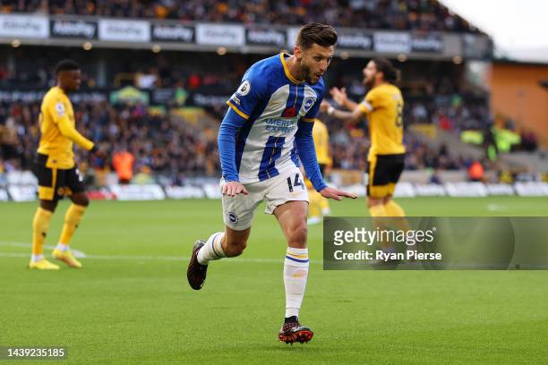 Adam Lallana of Brighton & Hove Albion celebrates after scoring their team's first goal during the Premier League match between Wolverhampton...