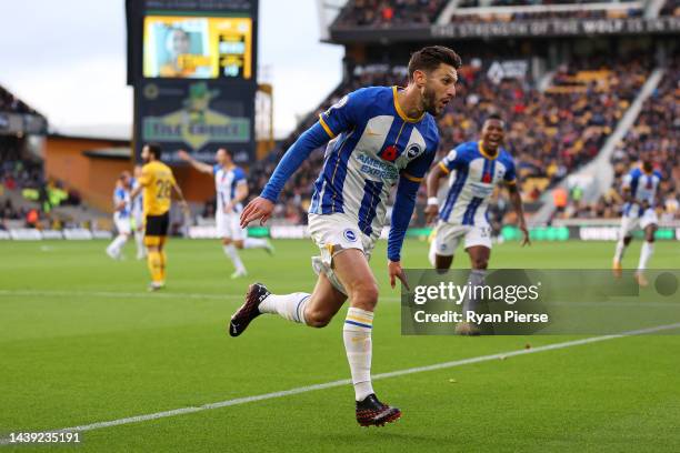 Adam Lallana of Brighton & Hove Albion celebrates after scoring their team's first goal during the Premier League match between Wolverhampton...