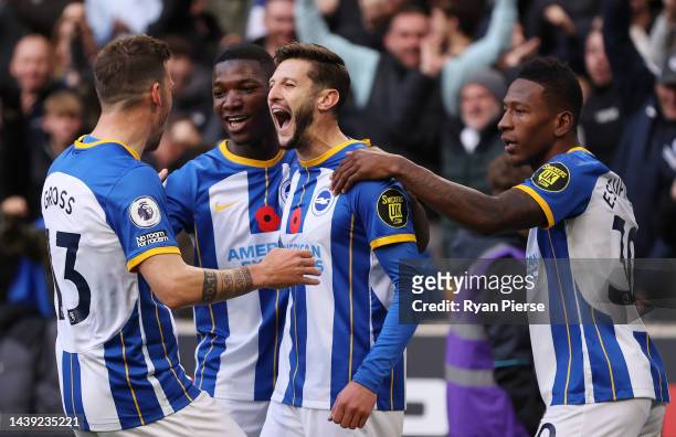 Adam Lallana of Brighton & Hove Albion celebrates with teammates after scoring their team's first goal during the Premier League match between...