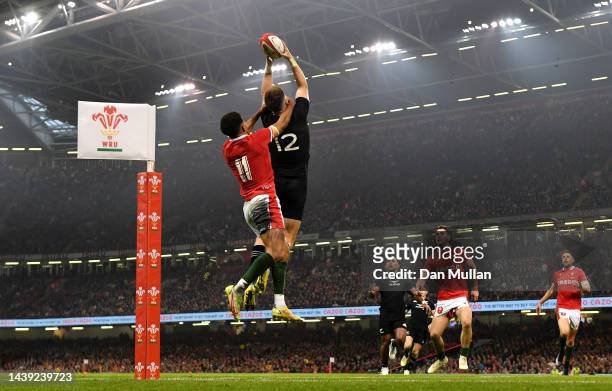 Jordie Barrett of New Zealand beats Rio Dyer of Wales to the high ball on the way to scoring his sides third try during the Autumn International...