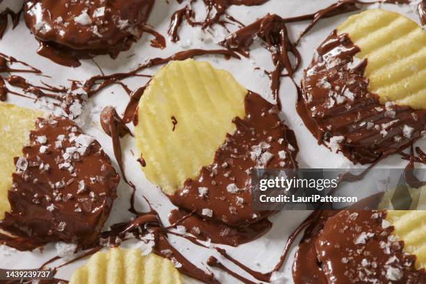 chocolate dipped potato chips - chips on paper stock pictures, royalty-free photos & images