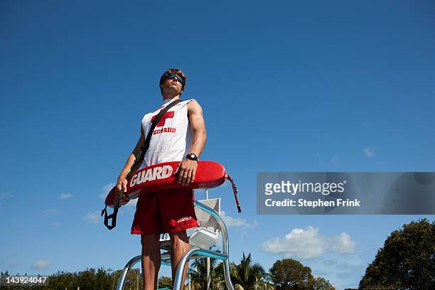 lifeguard on duty at swimming pool - lifeguard stock pictures, royalty-free photos & images
