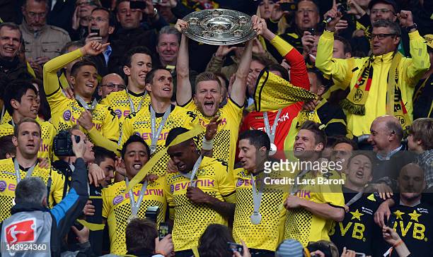 Jakub Blaszczykowski lifts the trophy after winning the Bundesliga match between Borussia Dortmund and SC Freiburg at Signal Iduna Park on May 5,...