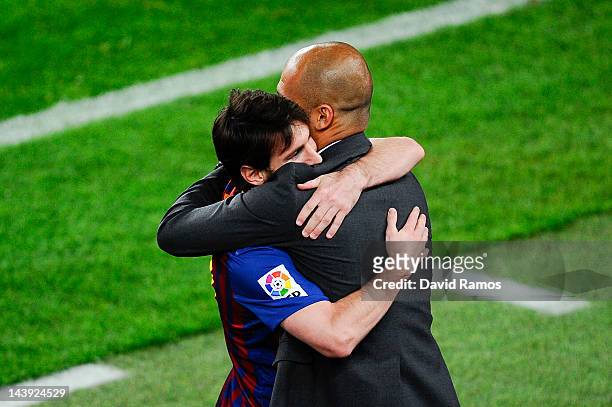 Lionel Messi of FC Barcelona hugs his Head coach Josep Guardiola of FC Barcelona after scoring his team's third goal during the La Liga match between...