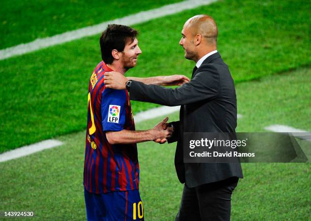 Lionel Messi of FC Barcelona shakes hands with his Head coach Josep Guardiola of FC Barcelona after scoring his team's third goal during the La Liga...