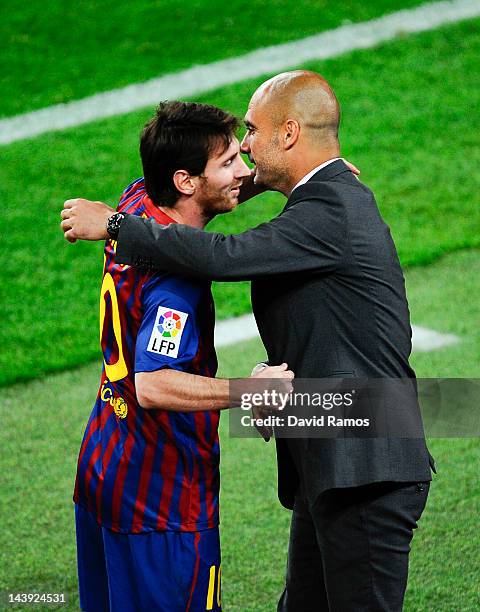 Lionel Messi of FC Barcelona shakes hands with his Head coach Josep Guardiola of FC Barcelona after scoring his team's third goal during the La Liga...