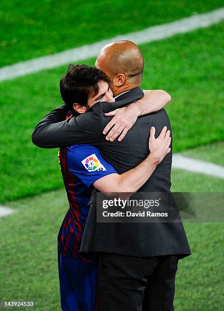 Lionel Messi of FC Barcelona hugs his Head coach Josep Guardiola of FC Barcelona after scoring his team's third goal during the La Liga match between...