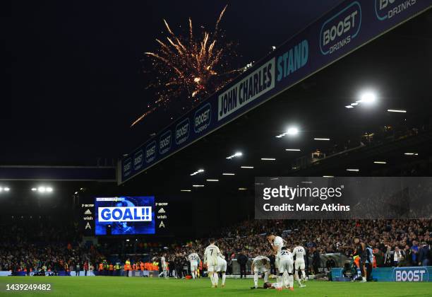 Crysencio Summerville of Leeds United celebrates with teammates after scoring their team's fourth goal as fireworks go off outside during the Premier...