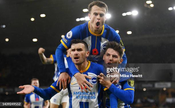 Pascal Gross of Brighton & Hove Albion celebrates with teammates after scoring their team's third goal during the Premier League match between...