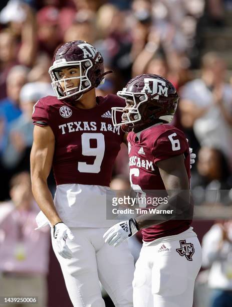 Noah Thomas of the Texas A&M Aggies congratulates Devon Achane after a touchdown in the first quarter against the Florida Gators at Kyle Field on...