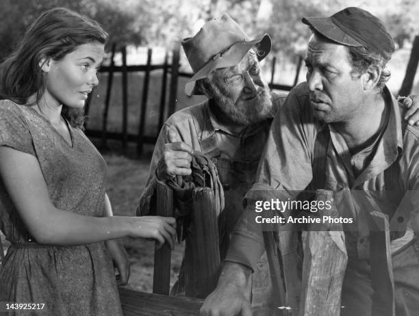 Gene Tierney and Charley Grapewin having conversation with Ward Bond outside in a scene from the film 'Tobacco Road', 1941.
