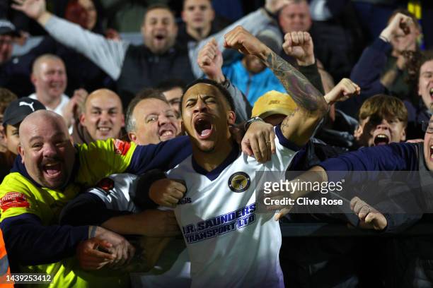 Michael Fernandes of Farnborough celebrates at the final whistle with the supporters after The Emirates FA Cup First Round between Sutton United and...