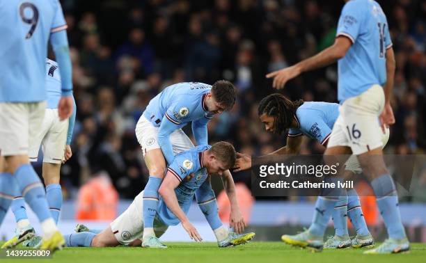 Kevin De Bruyne is picked up by John Stones of Manchester City during the Premier League match between Manchester City and Fulham FC at Etihad...