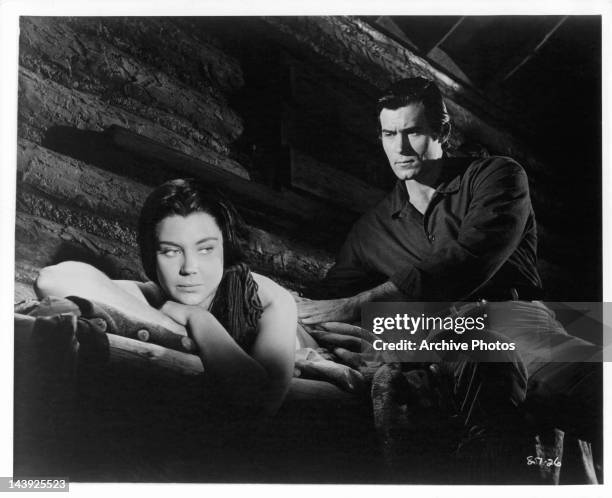 Andra Martin's bullet wound is checked by Clint Walker in a scene from the film 'Yellowstone Kelly', 1959.