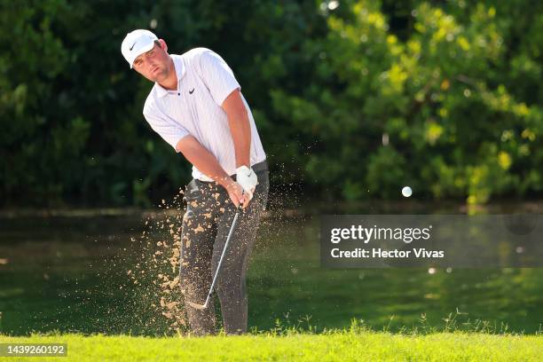 Scottie Scheffler of United States plays a shot on the from the sand onto the fifth green during the third round of the World Wide Technology...