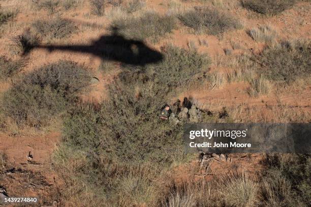 Border Patrol agent detains camouflaged Mexican migrants near the U.S.-Mexico border on November 04, 2022 near Naco, Arizona. CBP agents with U.S....