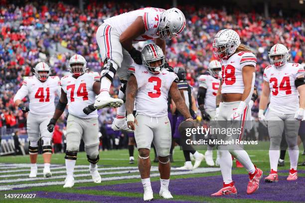Miyan Williams of the Ohio State Buckeyes celebrates with Paris Johnson Jr. #77 after rushing for a touchdown against the Northwestern Wildcats...