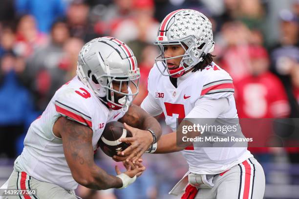 Stroud of the Ohio State Buckeyes hands the ball off to Miyan Williams against the Northwestern Wildcats during the second half at Ryan Field on...