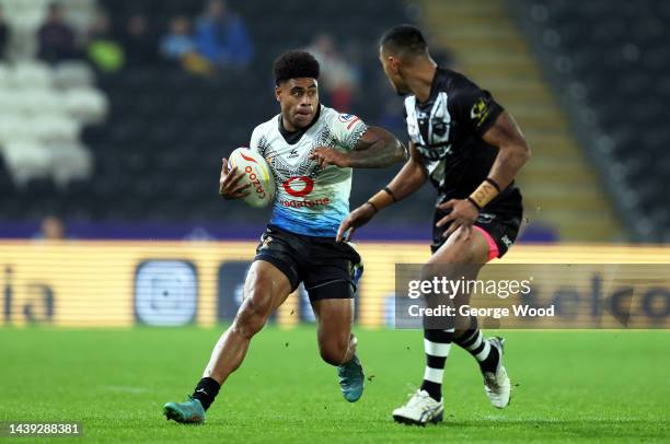 Kevin Naiqama of Fiji looks to break past Ronaldo Mulitalo of New Zealand during the Rugby League World Cup Quarter Final match between New Zealand...