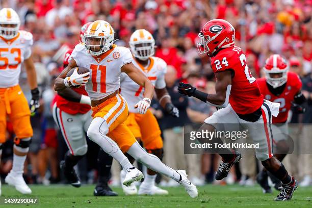 Jalin Hyatt of the Tennessee Volunteers carries the ball past Malaki Starks of the Georgia Bulldogs at Sanford Stadium on November 05, 2022 in...