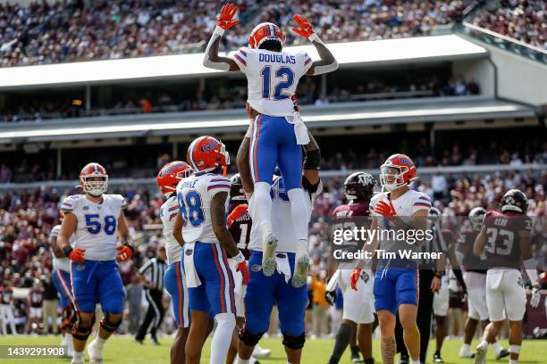Caleb Douglas of the Florida Gators is congratulated after a touchdown in the second half against the Texas A&M Aggies at Kyle Field on November 05,...