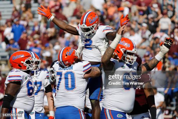 Montrell Johnson Jr. #2 of the Florida Gators is congratulated by teammates after rushing for a touchdown in the fourth quarter against the Texas A&M...