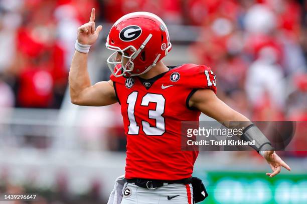 Stetson Bennett of the Georgia Bulldogs celebrates after a touchdown against the Tennessee Volunteers during the first quarter at Sanford Stadium on...