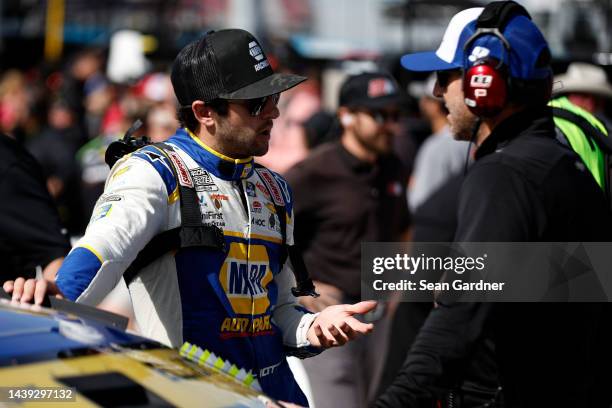 Chase Elliott, driver of the NAPA Auto Parts Chevrolet, and crew chief Alan Gustafson meet on the grid during qualifying for the NASCAR Cup Series...